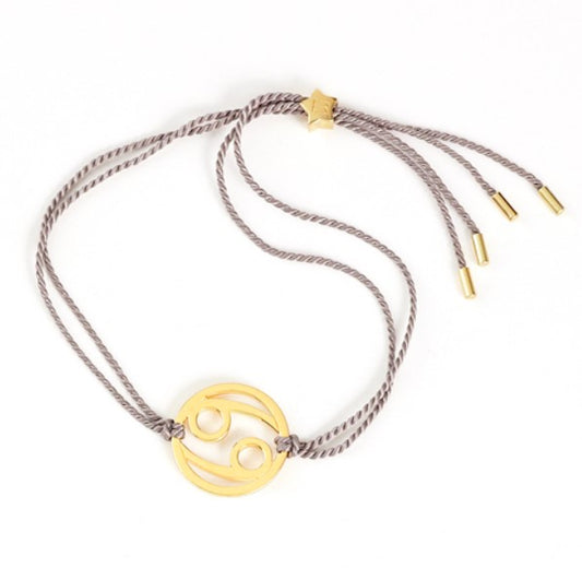 cancer zodiac bracelet in gold with silver cord